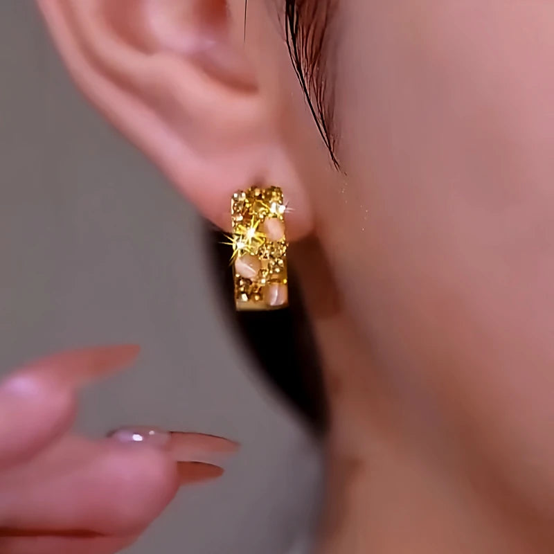 Angled view of the 14K Gold-Plated Luxury Brown Zircon Cat's Eye Hoop Earrings