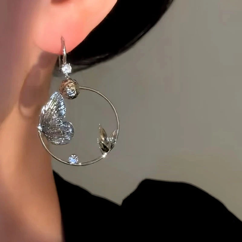 Model showcasing the dangle and style of the 14K Gold-Plated Luxury Butterfly Ear Hook Earrings