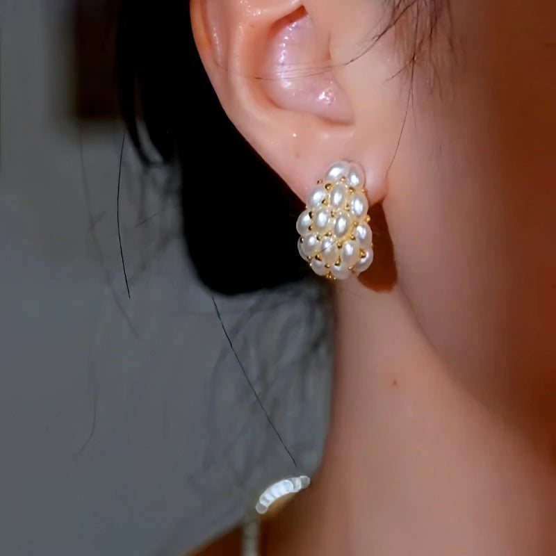 Model showcasing the dangle and style of the 14K Gold-Plated Luxury C-Shaped Pearl Earrings