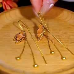 Close-up detail of the sparkling zircons and plating on the Cat's Eye Leaf Tassel