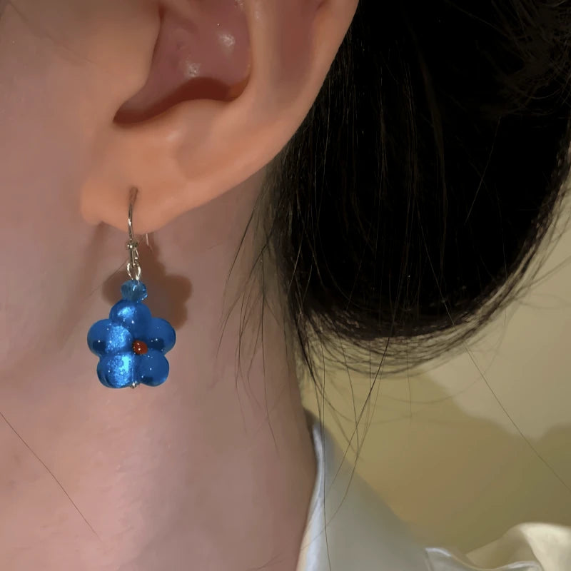 Model showcasing the dangle and style of the 14K Gold-Plated Luxury Cat's Eye Stone Blue Star Ear Hook Earrings