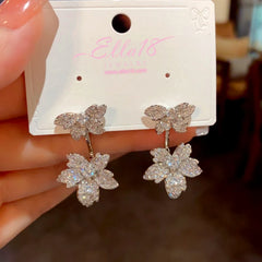 Model showcasing the dangle and style of the 14K Gold-Plated Luxury Design Zircon Diamond Maple Leaf Earrings