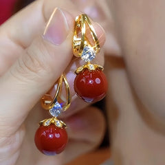 Close-up detail of the sparkling zircons and plating on the Red Pearl Earrings