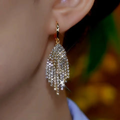 Model showcasing the dangle and style of the 14K Gold-Plated Luxury Diamond Leaf Tassel Earrings