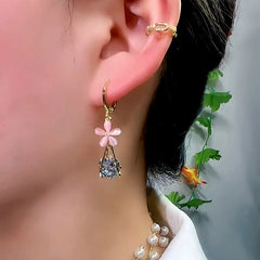 Model showcasing the dangle and style of the 14K Gold-Plated Luxury Diamond Pink Flower Earrings