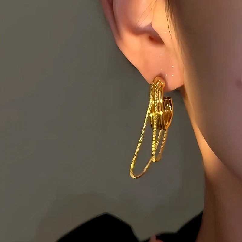 Model showcasing the dangle and style of the 14K Gold-Plated Luxury Double-Layer Chain Tassel Earrings