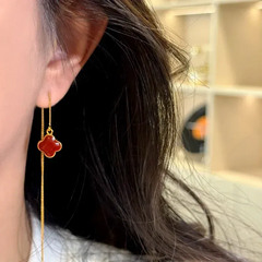 Model showcasing the dangle and style of the 14K Gold-Plated Luxury Four-Leaf Flower Threader Earrings