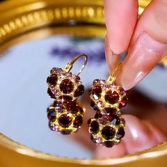 Model showcasing the dangle and style of the 14K Gold-Plated Luxury Full Diamond Purple Crystal Basket Earrings