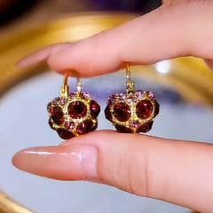 Angled view of the 14K Gold-Plated Luxury Full Diamond Purple Crystal Basket Earrings