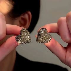 Close-up detail of the sparkling zircons and plating on the Grey Heart Studs