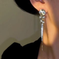 Model showcasing the dangle and style of the 14K Gold-Plated Luxury Long Fan Tassel Earrings