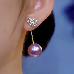 Model showcasing the dangle and style of the 14K Gold-Plated Luxury Purple Pearl Diamond Heart Earrings