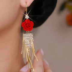 Model showcasing the dangle and style of the 14K Gold-Plated Luxury Red Rose Diamond Tassel Ear Hook Earrings