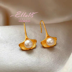 Model showcasing the dangle and style of the 14K Gold-Plated Luxury Shell Pearl Ear Hook Earrings