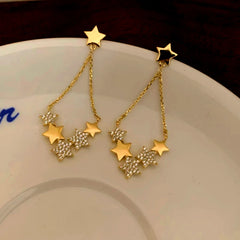Angled view of the 14K Gold-Plated Luxury Star Tassel Earrings