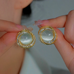 Model showcasing the dangle and style of the 14K Gold-Plated Luxury Zircon Cat's Eye Stone Stud Earrings