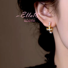 Close-up detail of the sparkling zircons and plating on the Cross Pearl Earrings