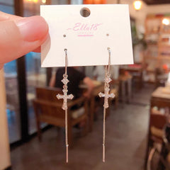 Angled view of the 14K Gold-Plated Luxury Zircon Diamond Cross Threader Earrings