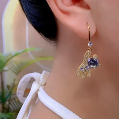 Model showcasing the dangle and style of the 14K Gold-Plated Luxury Zircon Diamond Golden Bear Ear Hook Earrings