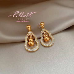 Model showcasing the dangle and style of the 14K Gold-Plated Luxury Zircon Diamond Gourd Earrings