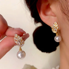 Close-up detail of the sparkling zircons and plating on the Leaf Pearl Earrings