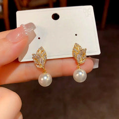 Model showcasing the dangle and style of the 14K Gold-Plated Luxury Zircon Diamond Leaf Pearl Earrings