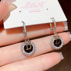 Model showcasing the dangle and style of the 14K Gold-Plated Luxury Zircon Diamond Letter D Earrings