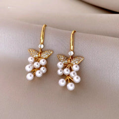 Model showcasing the dangle and style of the 14K Gold-Plated Luxury Zircon Diamond Pearl Tassel Ear Hook Earrings