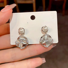 Close-up detail of the sparkling zircons and plating on the Geometric Pearl Earrings