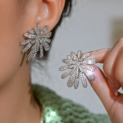 Model showcasing the dangle and style of the 14K Gold-Plated Luxury Zircon Firework Earrings