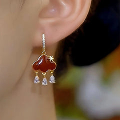 Model showcasing the dangle and style of the 14K Gold-Plated Luxury Zircon Peace Lock Earrings