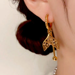 Close-Up of Gold Mermaid Tail Champagne Crystal Drop Earring Worn on Ear