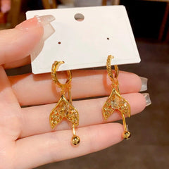 Pair of Gold Mermaid Tail Champagne Crystal Dangle Earrings on Jewelry Card