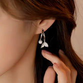 Silver Mermaid Tail Pearl Drop Hoop Earring on Woman's Ear Closeup
