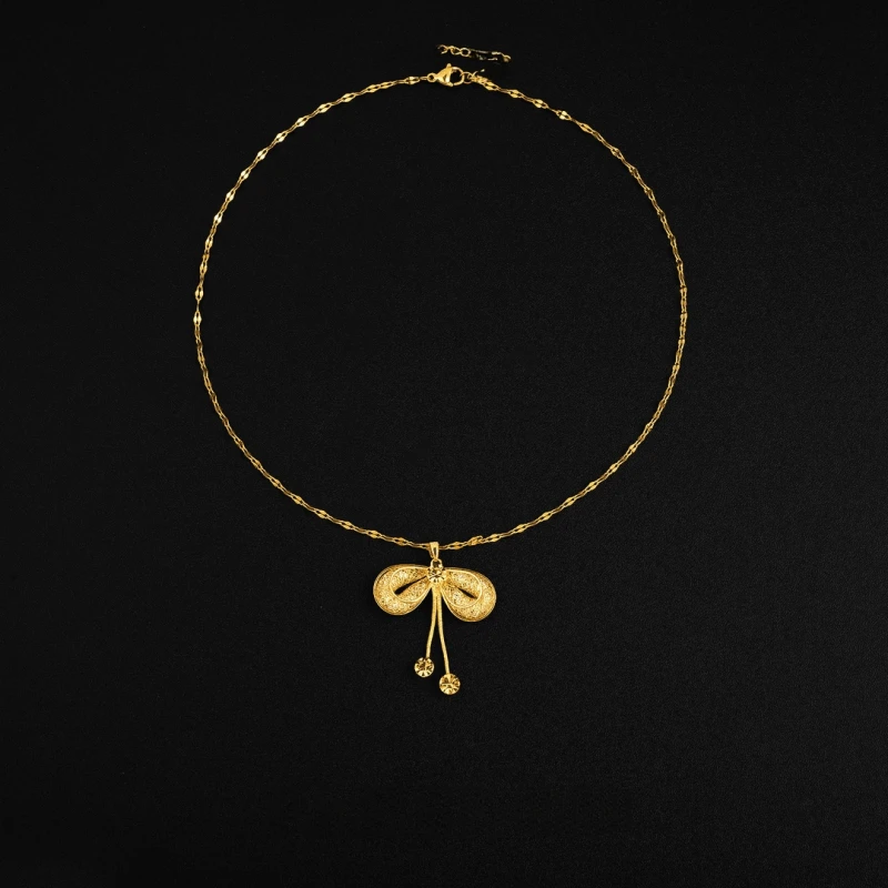 Detailed view of the 14K Gold-Plated Mesh Butterfly Bow Pendant Necklace chain and pendant