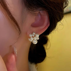 Model showcasing the dangle and style of the 14K Gold-Plated Micro-Diamond Beaded Flower Bud Earrings