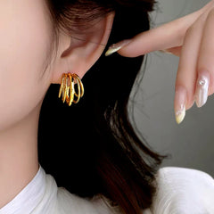 Close up of gold layered hoop earring worn on a woman's ear