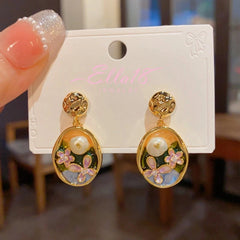 Angled view of the 14K Gold-Plated Oil-Dripping Freshwater Pearl Flower Oval Earrings