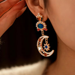 Angled view of the 14K Gold-Plated Oil-Drop Diamond Moon Star Flower Pearl Earrings