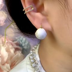 Model showcasing the dangle and style of the 14K Gold-Plated Oil Drop Basket Earrings