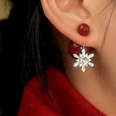 Red bead crystal snowflake drop earring worn on female ear, festive winter jewelry