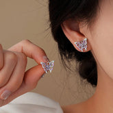 Dainty purple mint enamel butterfly stud earrings, one worn one held in hand