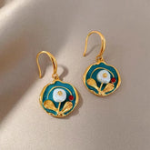 Teal enamel gold floral drop earrings with baroque pearl on beige satin