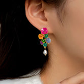 Vibrant multicolor enamel flower cluster pearl drop earring on woman's ear
