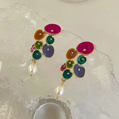 Pair of colorful enamel flower cluster pearl drop earrings on frosted display