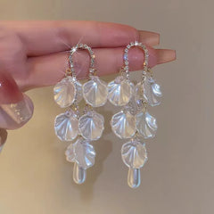 Angled view of the 14K Gold-Plated Pearl Petal Tassel Earrings