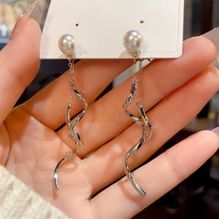 Angled view of the 14K Gold-Plated Pearl Spiral Tassel Earrings