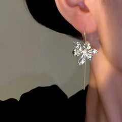 Model showcasing the dangle and style of the 14K Gold-Plated Phoenix Iris Flower Threader Earrings