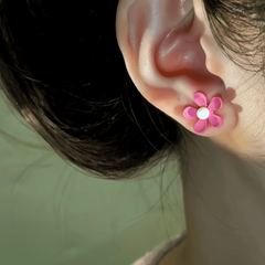 Close-up detail of the sparkling zircons and plating on the Pink Flower Studs