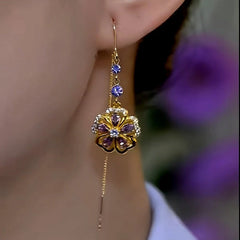 Gold purple crystal floral long tassel drop earring on woman's ear